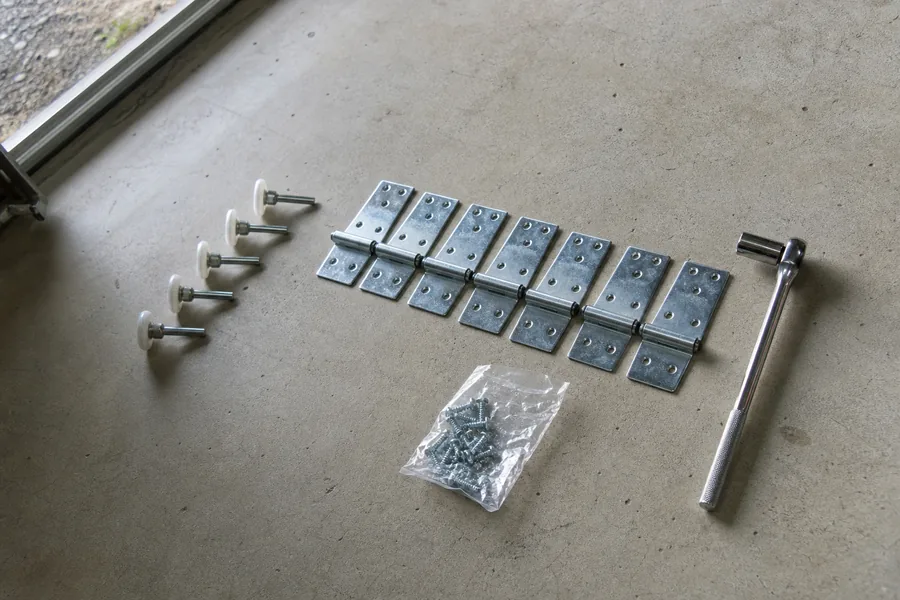 New rollers and hinges ready for a garage door in Amarillo, TX